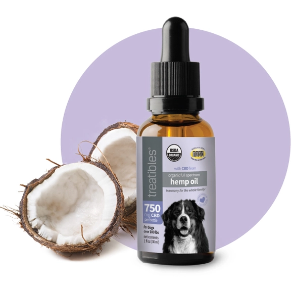 Treatibles Organic Full Spectrum Hemp Oil 750 mg CBD oil in a brown oil dropper bottle with a light purple label featuring a large black and white dog with coconut oil