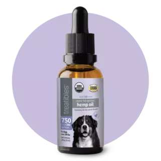 Treatibles Organic Full Spectrum Hemp Oil 750 mg CBD oil in a brown oil dropper bottle with a light purple label featuring a large black and white dog.