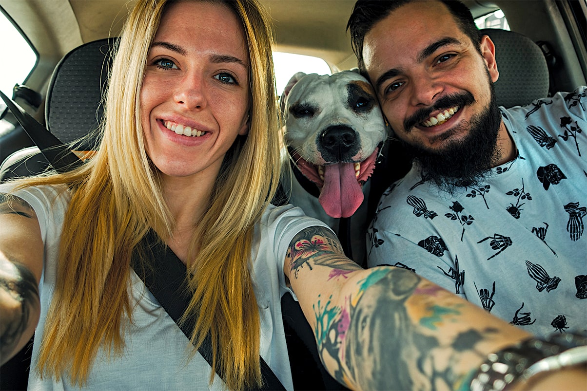 NewlA couple takes a selfie in the car with their newly adopted senior dog during Celebrate Pets in Shelters day
