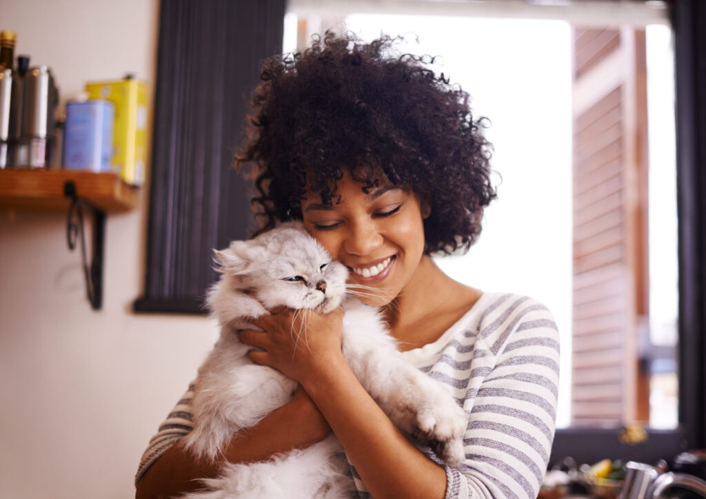 beautiful young woman showing love by enjoying a cuddle with her cat
