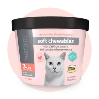Front of pink canister of Treatibles Extra Strength CBD Soft Chewables for Cats with two heart-shaped Chewables on the right and a salmon filet on the left